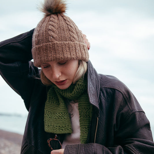 This alpaca wool cable hat knitting kit uses alpaca yarn from British and Irish farms. Shown here in Sandstone.