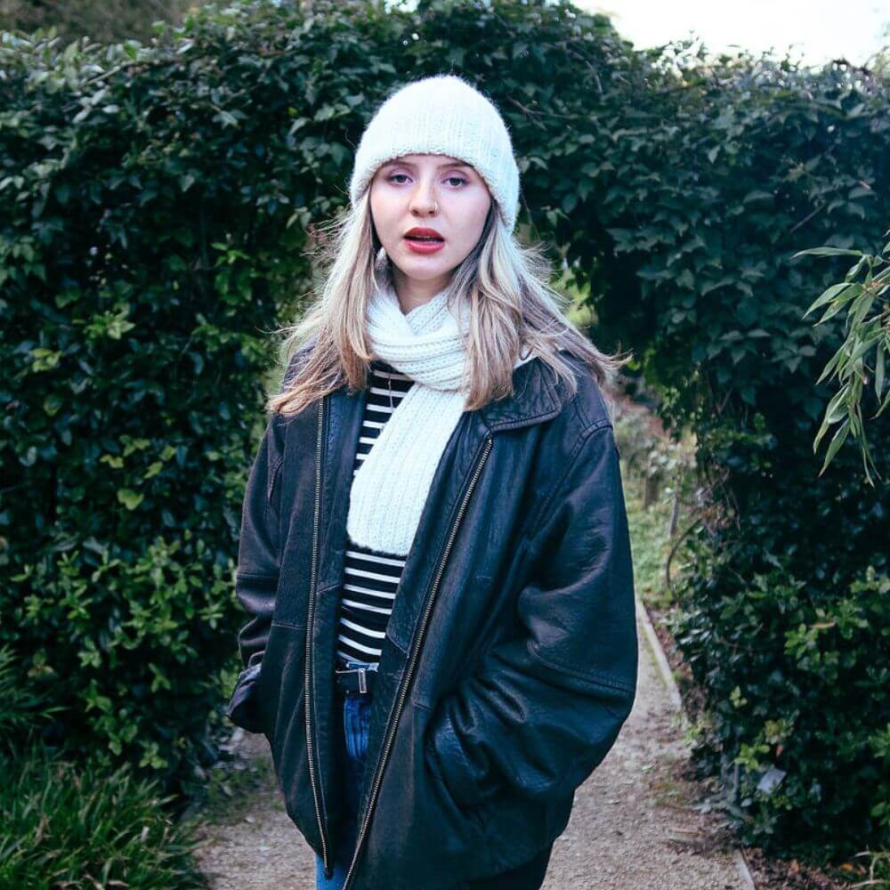 Model wearing chunky alpaca Seaman's hat and scarf knitted from Gorgeous Alpacas pattern – shown in Parchment.