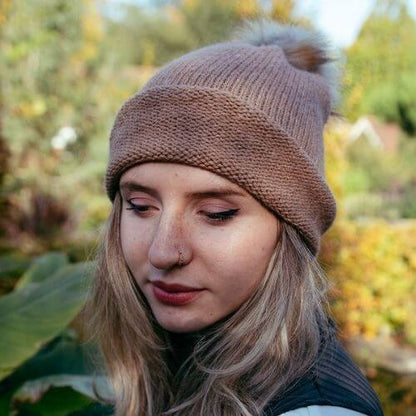 Kiki wearing the beginner hat rolled up knitted in DK alpaca wool from British and Irish farms