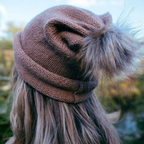 Kiki wearing the beginner hat rolled up knitted in DK alpaca wool from British and Irish farms rear view