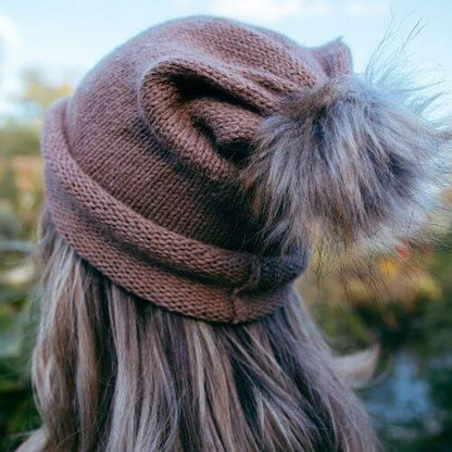 Kiki wearing the beginner hat rolled up knitted in DK alpaca wool from British and Irish farms rear view