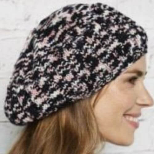 Model wearing Manos Alegria Grande Cabaret beret knit kit