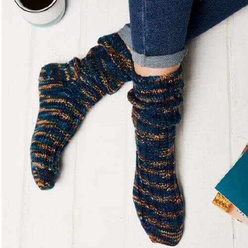 Manos Sofa Socks for Men worn by model in relaxed environment