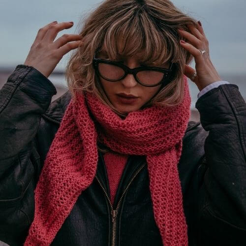 Model wearing Gorgeous Alpacas Restful Lacy scarf knitted in DK weight alpaca wool