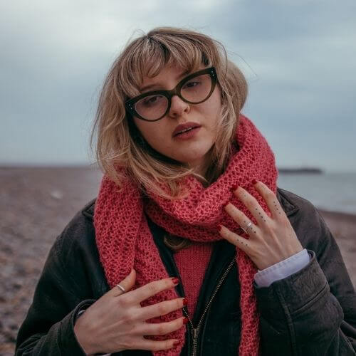 Kiki wearing the Gorgeous Alpacas Lacy Scarf knitting kit shown here in Rose Pink Gorgeous Alpacas wool (75% alpaca, 25% wool) from British and Irish farms.