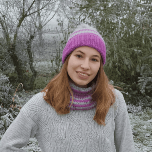 Alpaca wool knitting kit for the family ribbed striped hat shown here in Lilac and lunar grey with a silver pompom, worn here by Yasya
